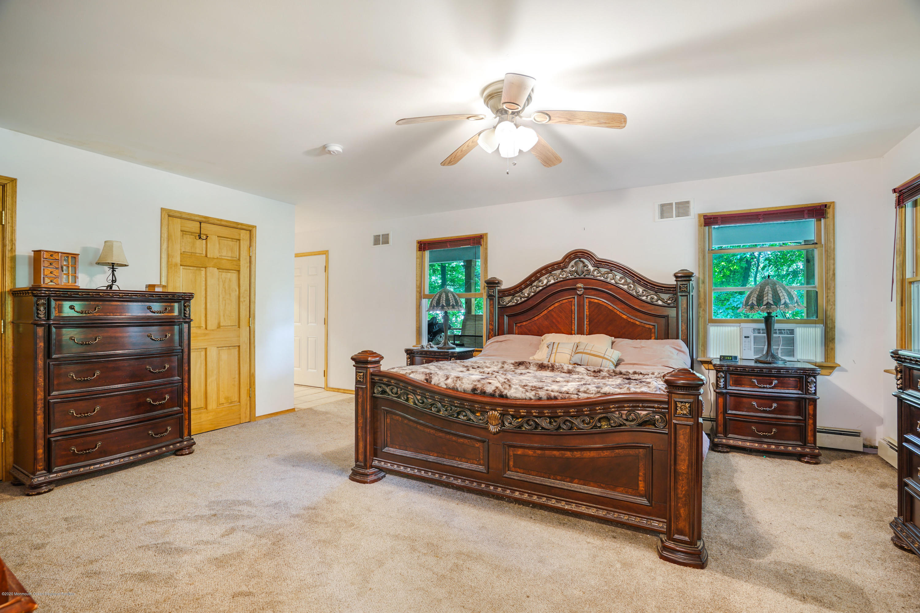 60 Oak Glen Road Howell, NJ 07731 - Photo 27 of 74 a bedroom with a bed and a chandelier