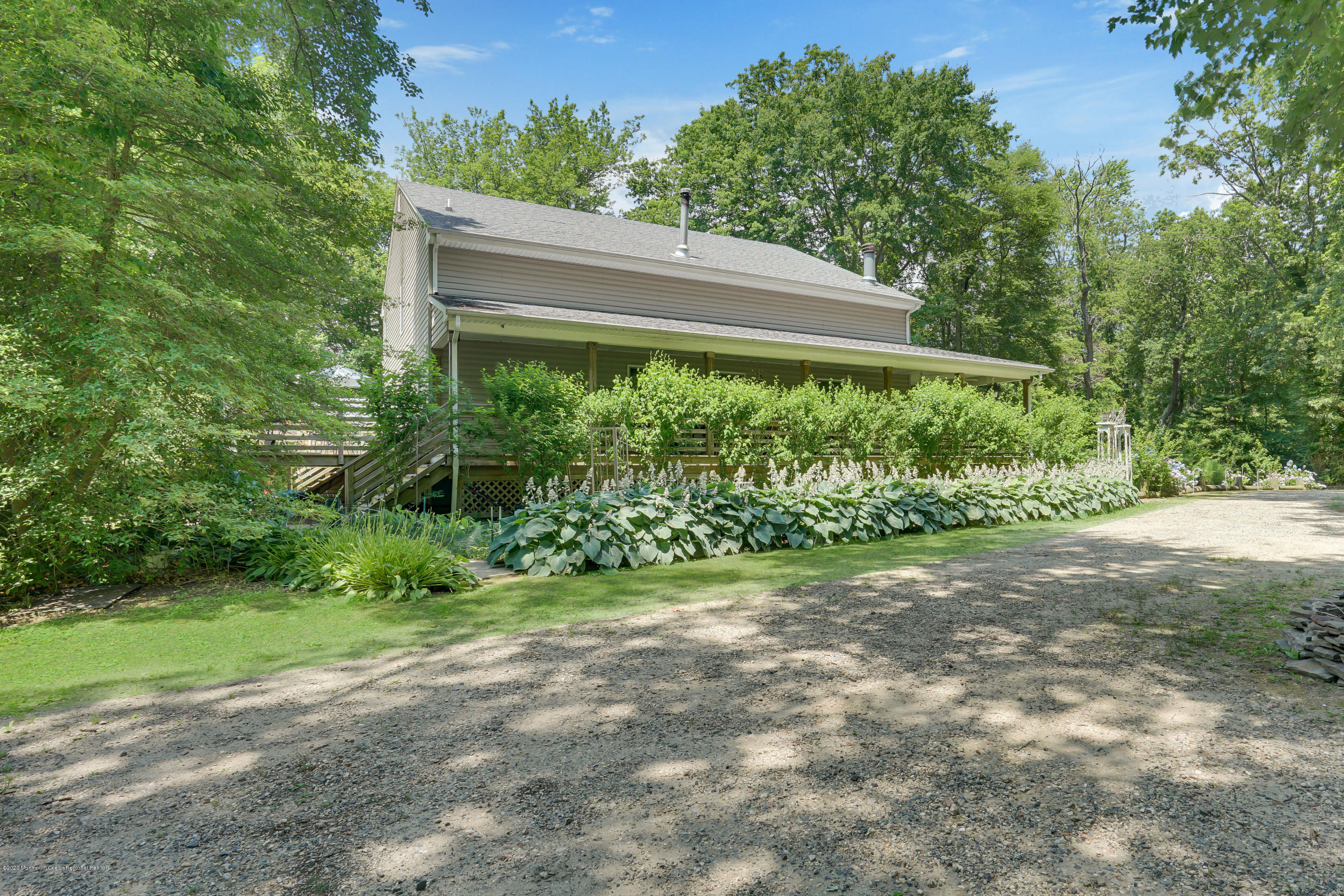 60 Oak Glen Road Howell, NJ 07731 - Photo 4 of 74 a view of a backyard with plants and large trees