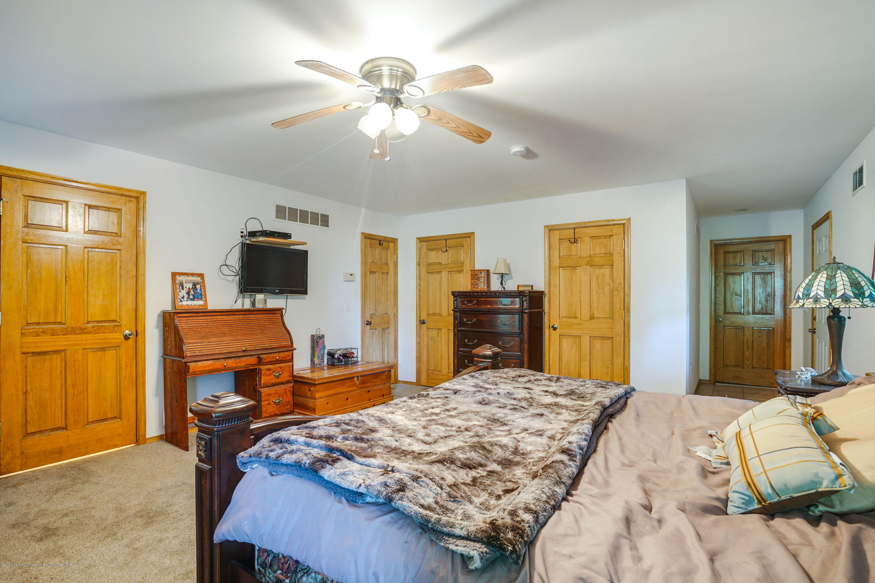 60 Oak Glen Road Howell, NJ 07731 - Photo 35 of 74 a bedroom with a bed and wooden floor