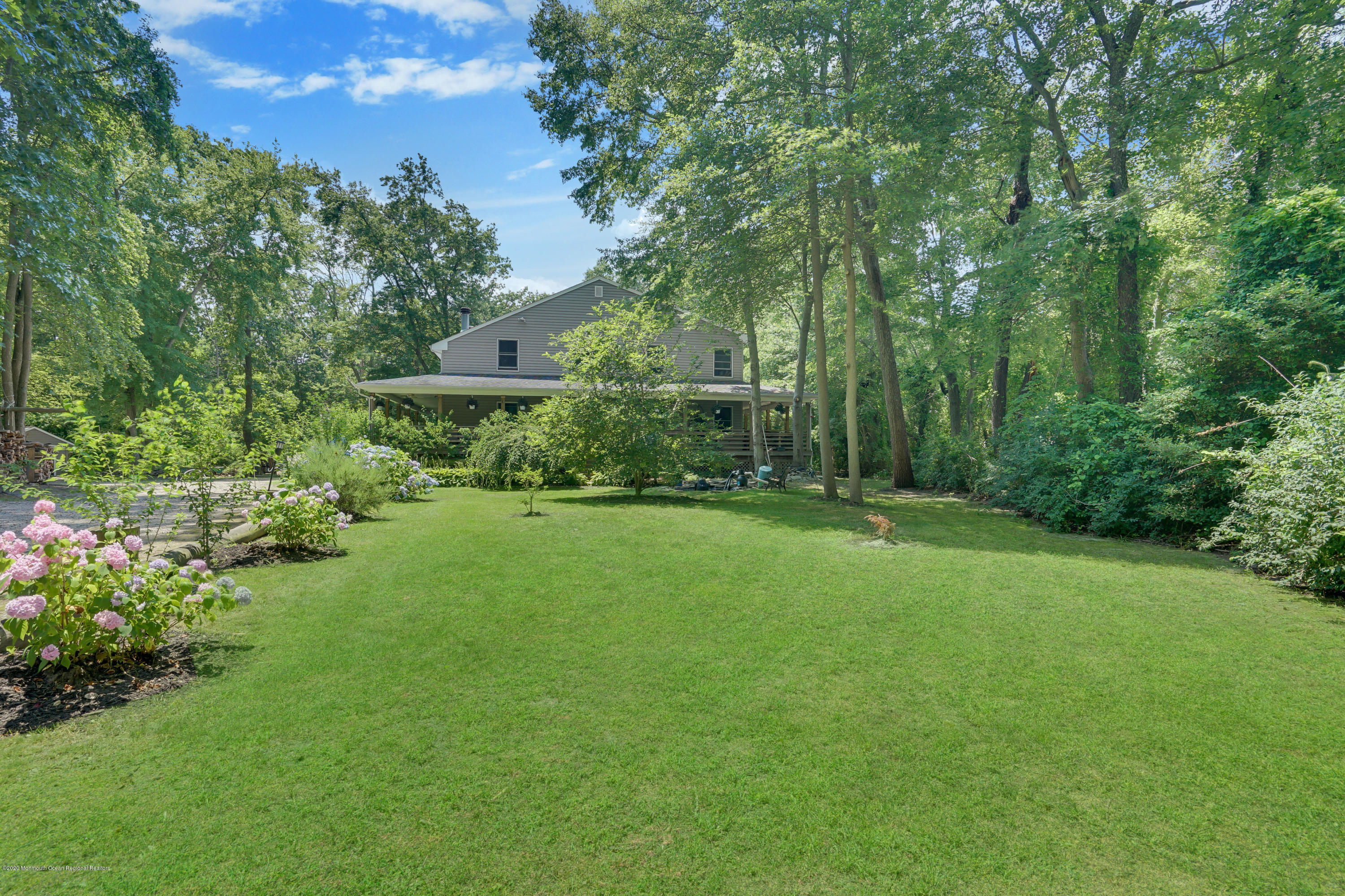 60 Oak Glen Road Howell, NJ 07731 - Photo 5 of 74 a view of a garden with a building in the background