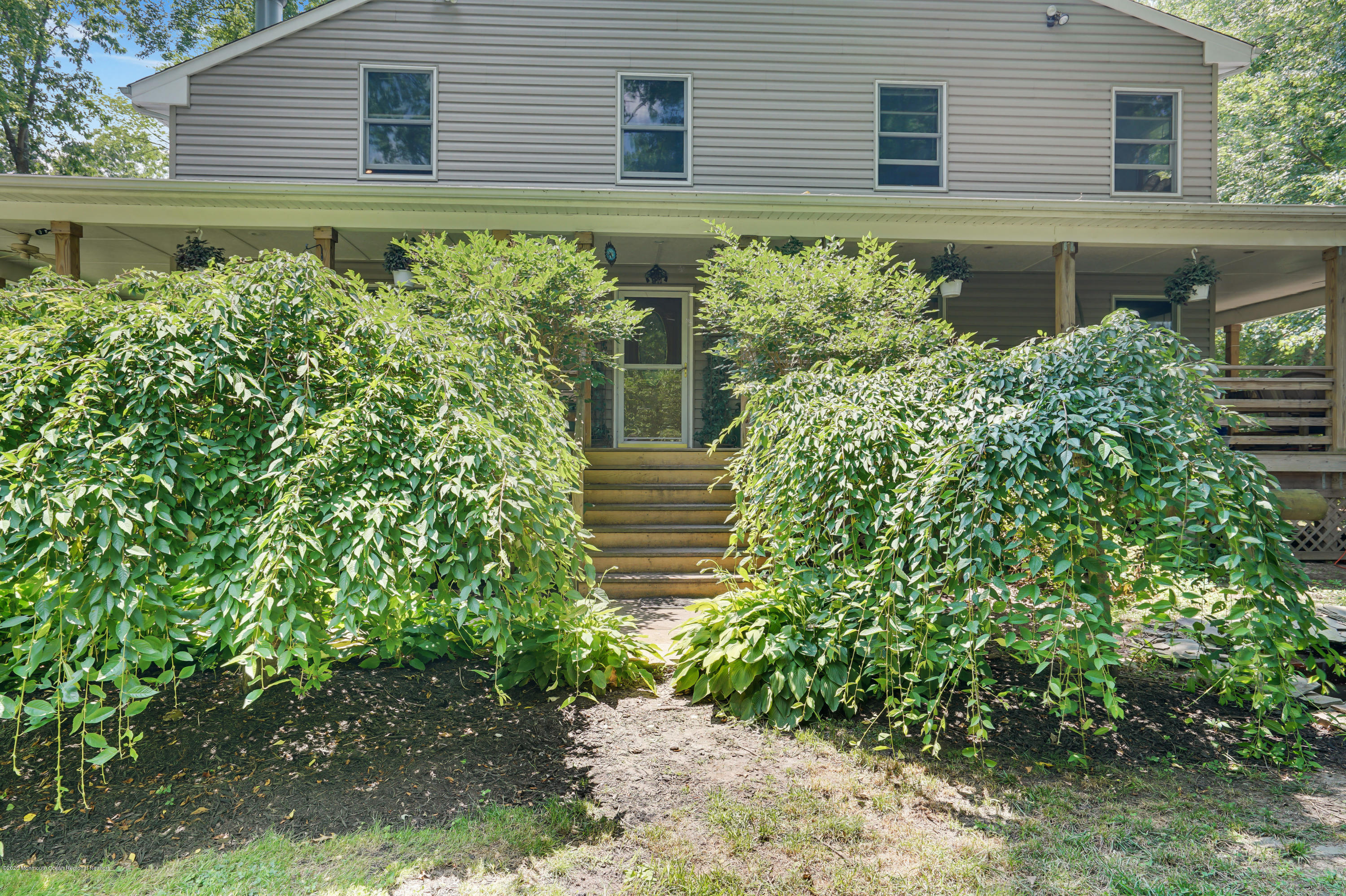 60 Oak Glen Road Howell, NJ 07731 - Photo 68 of 74 a house with a flower garden in front of it