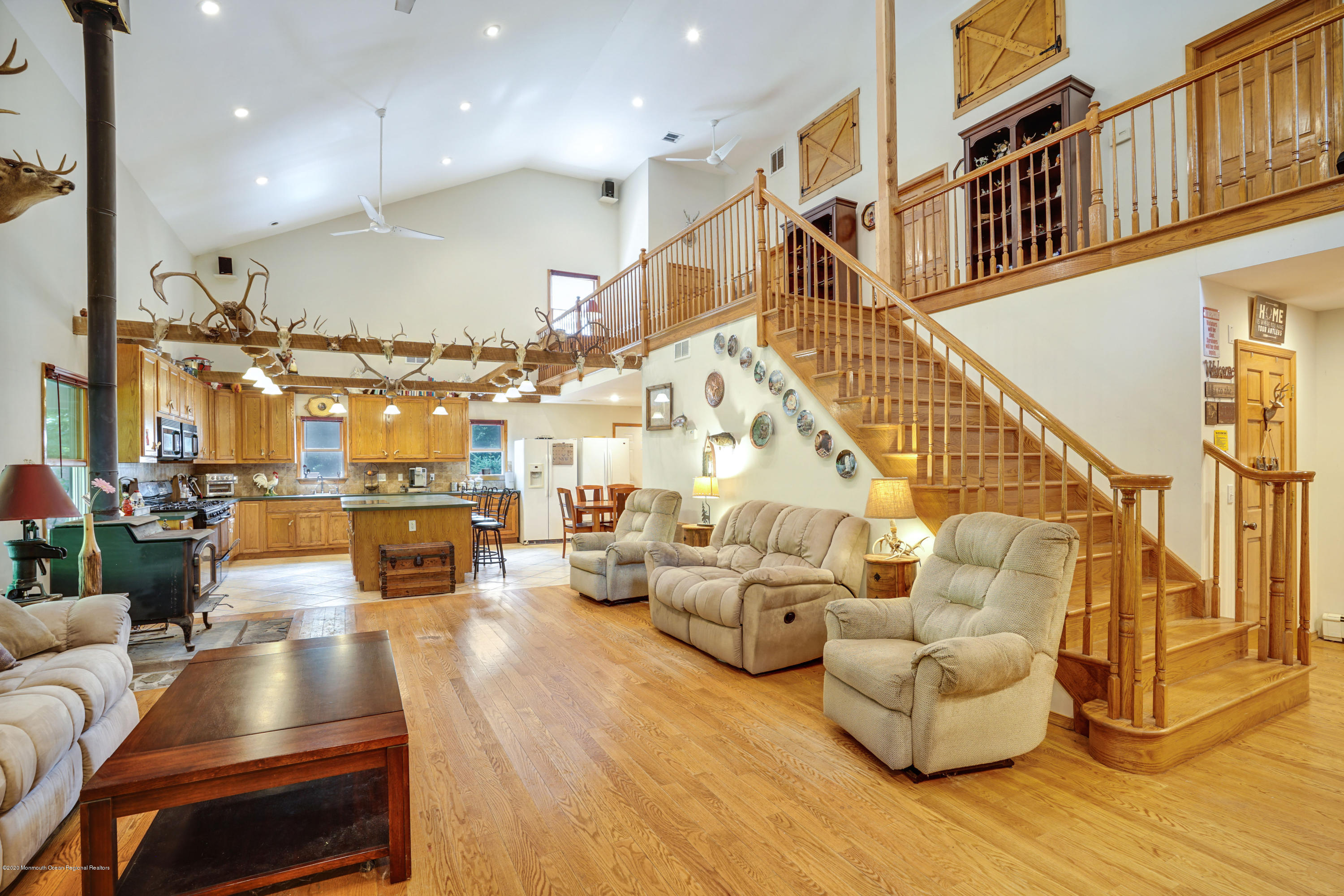 60 Oak Glen Road Howell, NJ 07731 - Photo 9 of 74 a living room with couches and kitchen view with wooden floor