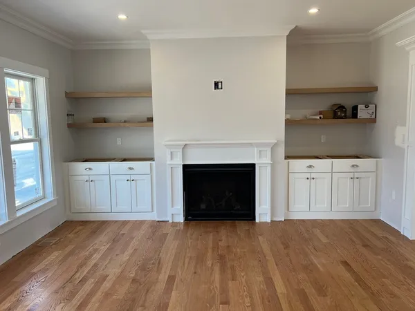 a view of a kitchen with a sink and a fireplace