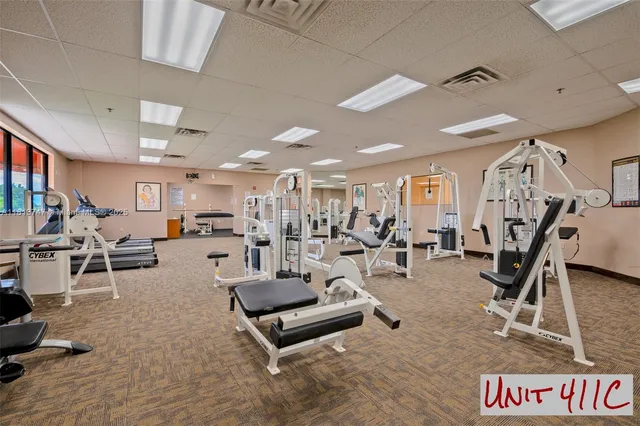 a living room with lots of furniture and gym equipment