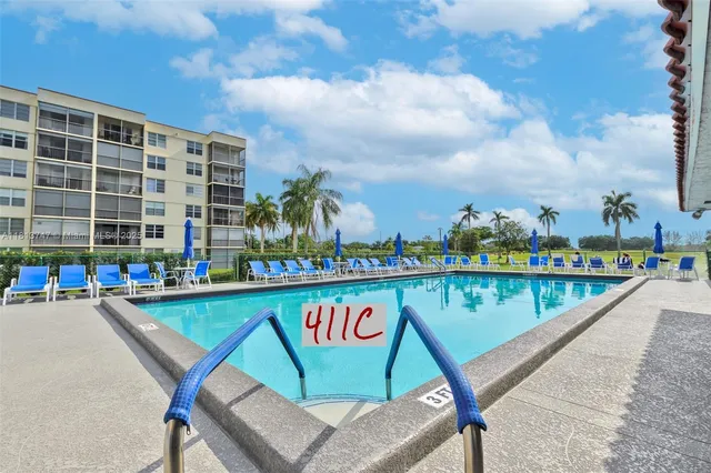 a view of swimming pool with outdoor seating and plants