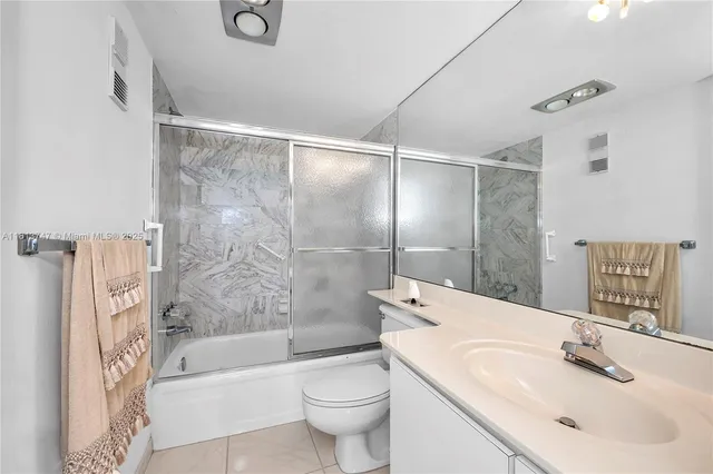 a bathroom with a sink mirror toilet and bathtub