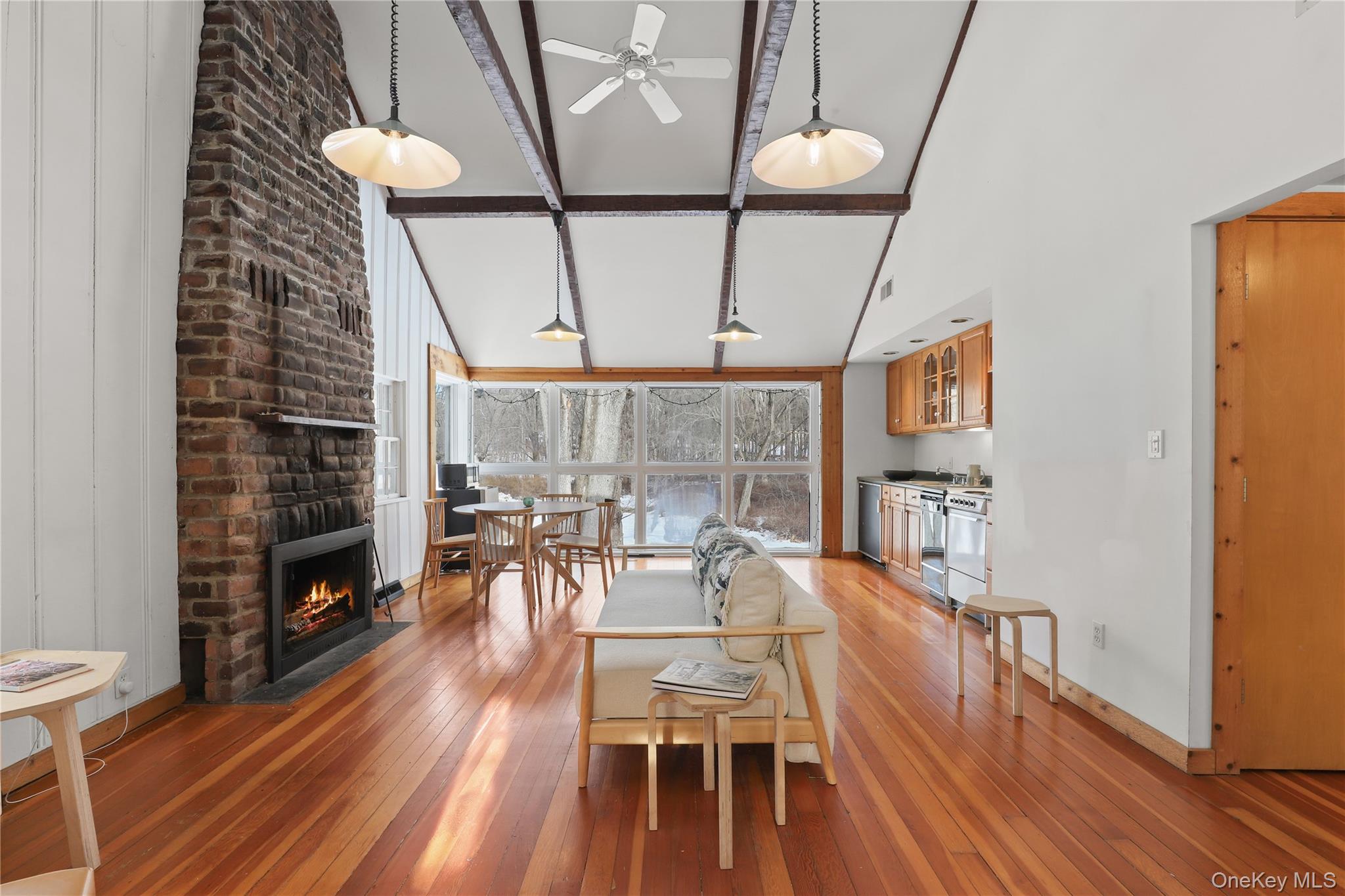64 Pound Ridge Road Pound Ridge, NY 10576 - Photo 16 of 25 Living room/dining area and kitchen with/fireplace.