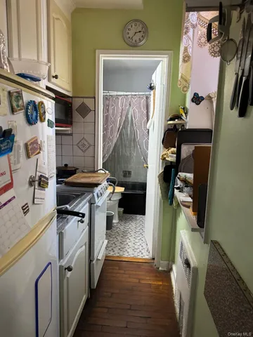 a kitchen with stainless steel appliances granite countertop a stove and a refrigerator