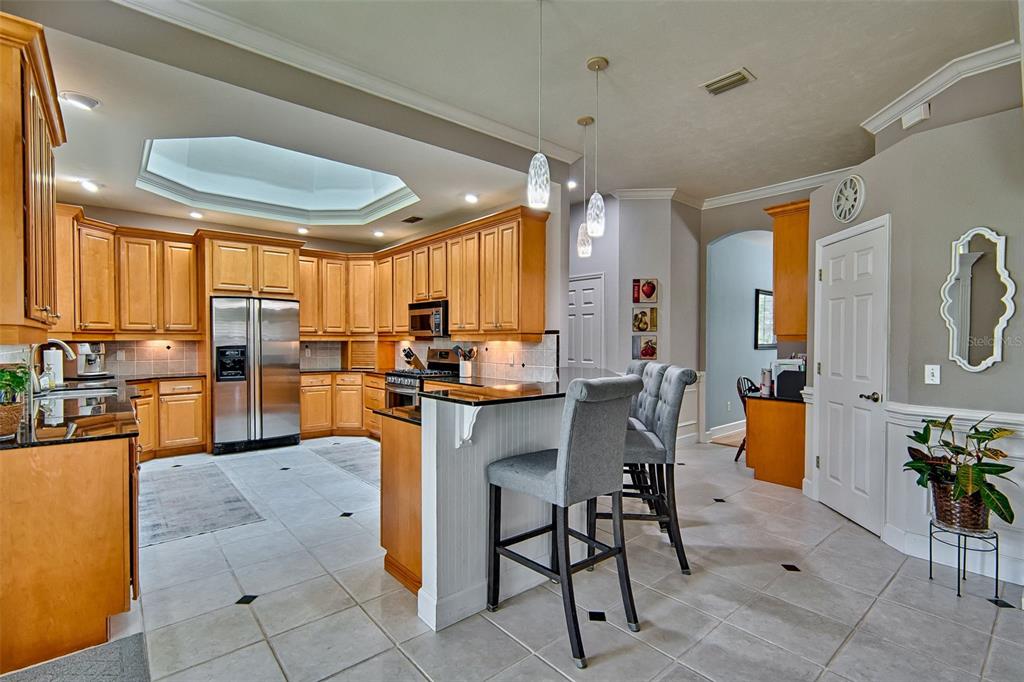 10912 Southwest 17 Lane Gainesville, FL 32607 - Photo 11 of 67 a room with stainless steel appliances kitchen island granite countertop furniture and a view of living room