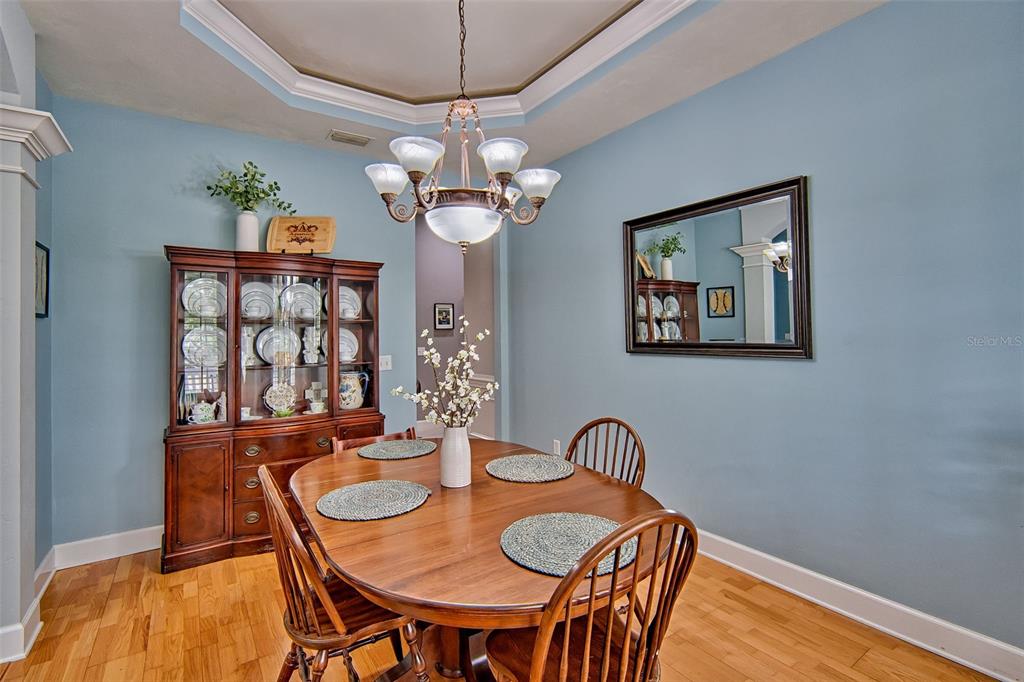 10912 Southwest 17 Lane Gainesville, FL 32607 - Photo 17 of 67 a view of a dining room with furniture wooden floor and chandelier