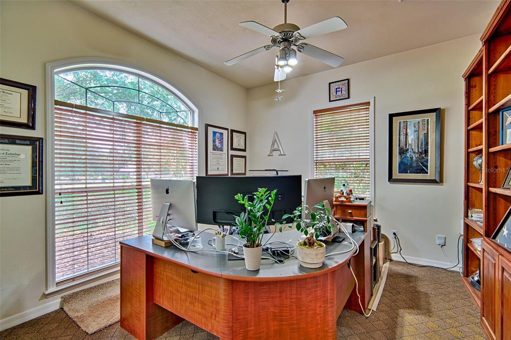 10912 Southwest 17 Lane Gainesville, FL 32607 - Photo 24 of 67 a dining room with furniture a flat screen tv and a chandelier