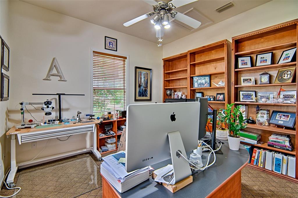 10912 Southwest 17 Lane Gainesville, FL 32607 - Photo 25 of 67 a room with furniture a bookshelf and a window