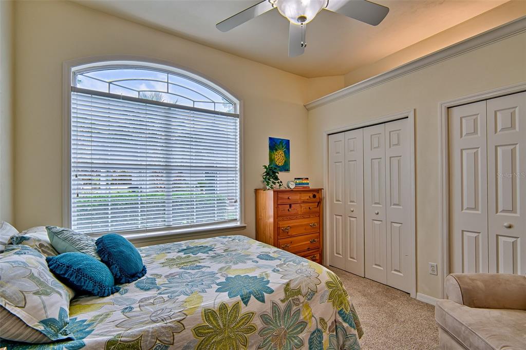 10912 Southwest 17 Lane Gainesville, FL 32607 - Photo 26 of 67 a bedroom with a bed dresser and a chandelier