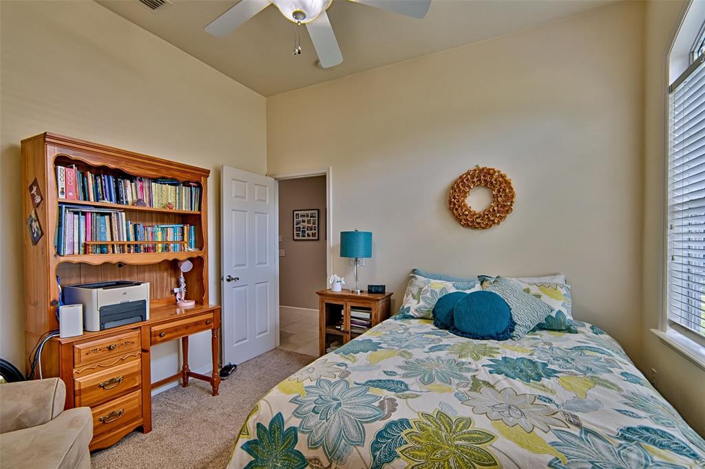 10912 Southwest 17 Lane Gainesville, FL 32607 - Photo 27 of 67 a bedroom with a bed dresser and a book shelf