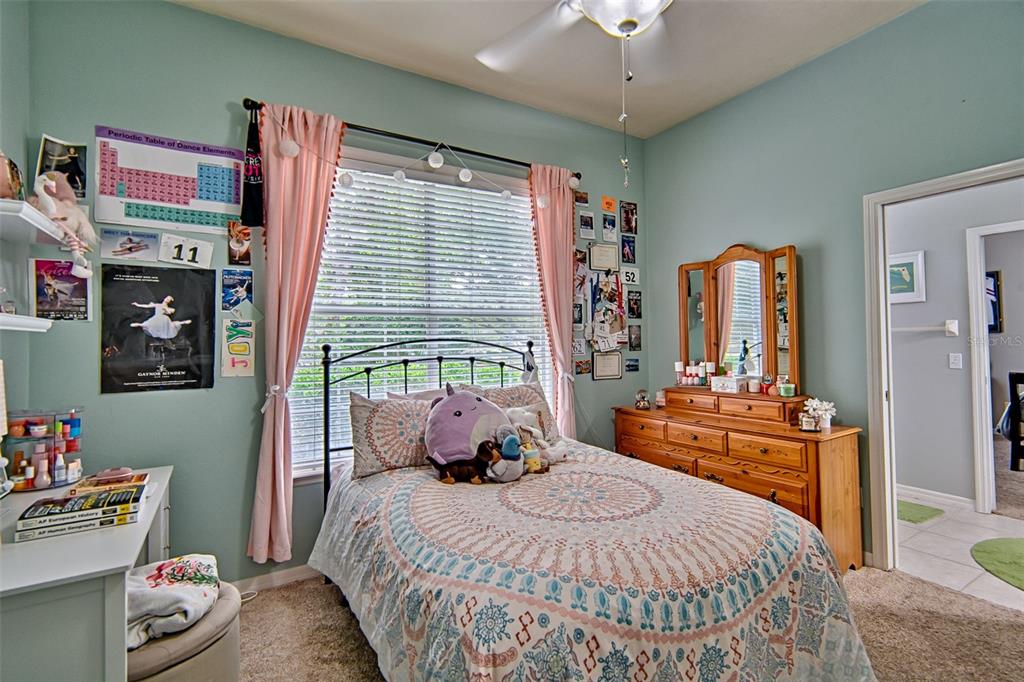 10912 Southwest 17 Lane Gainesville, FL 32607 - Photo 32 of 67 a bedroom with a bed and a chandelier