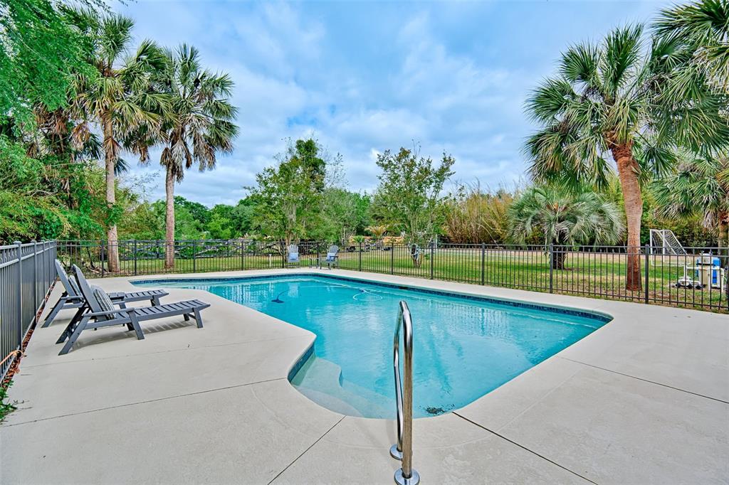 10912 Southwest 17 Lane Gainesville, FL 32607 - Photo 4 of 67 a view of a swimming pool with a lounge chair