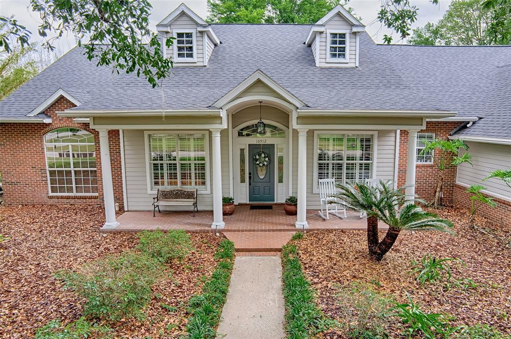 10912 Southwest 17 Lane Gainesville, FL 32607 - Photo 67 of 67 a front view of a house with garden and porch
