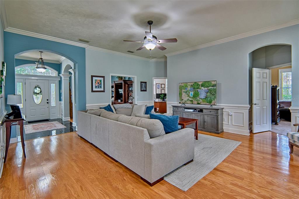 10912 Southwest 17 Lane Gainesville, FL 32607 - Photo 7 of 67 a living room with furniture and a wooden floor
