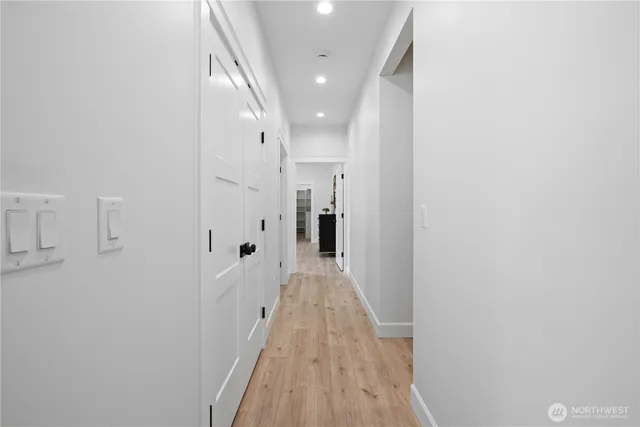 a view of a hallway with wooden floor