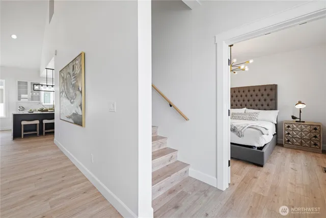 a bedroom with furniture and wooden floor