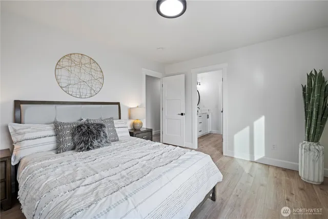 a bedroom with a bed and a potted plant