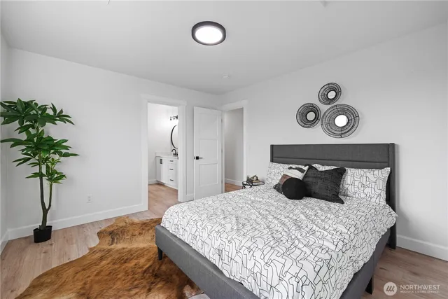 a bedroom with a bed and a potted plant