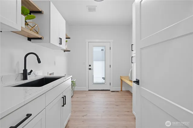 a kitchen with a sink and a refrigerator
