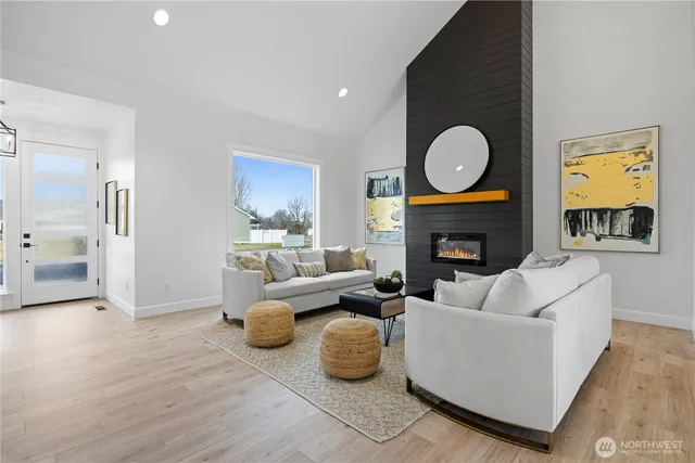 a living room with fireplace furniture and a fireplace