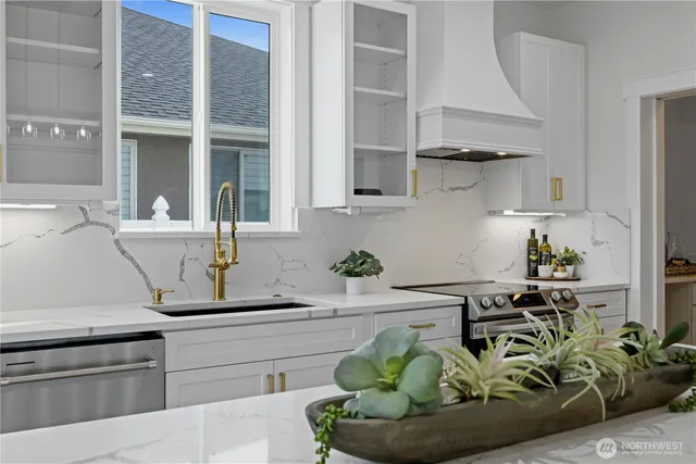 a kitchen with white cabinets and a sink