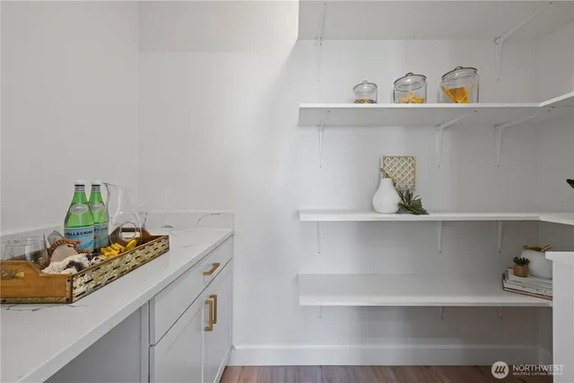 a view of kitchen cabinets a sink and wooden floor