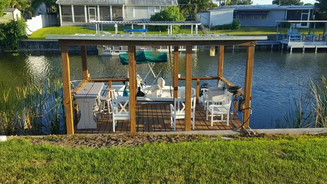 a view of a house with a yard and sitting area