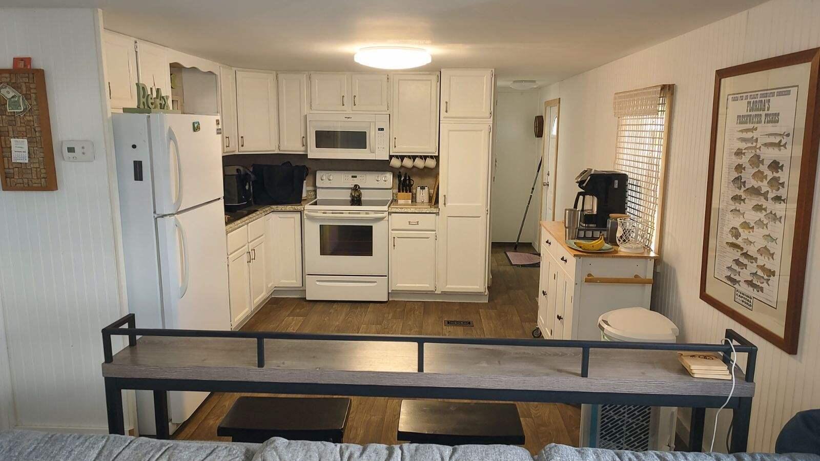 2044 Southeast 34th Lane Okeechobee, FL 34974 - Photo 3 of 11 a kitchen with stainless steel appliances a refrigerator and stove