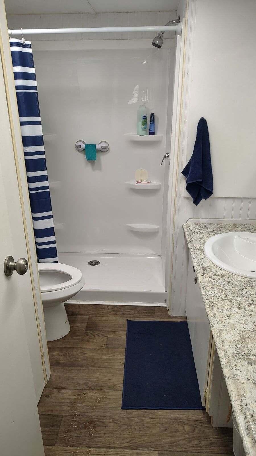 2044 Southeast 34th Lane Okeechobee, FL 34974 - Photo 6 of 11 a bathroom with a granite countertop sink toilet and shower