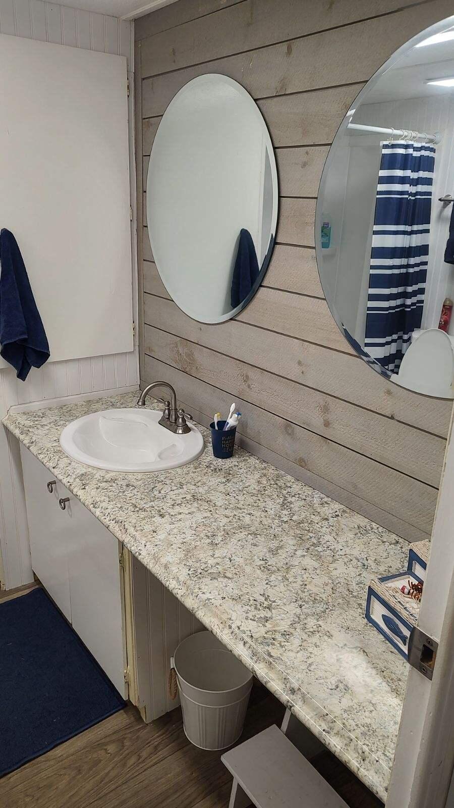 2044 Southeast 34th Lane Okeechobee, FL 34974 - Photo 7 of 11 a bathroom with a granite countertop sink and a mirror