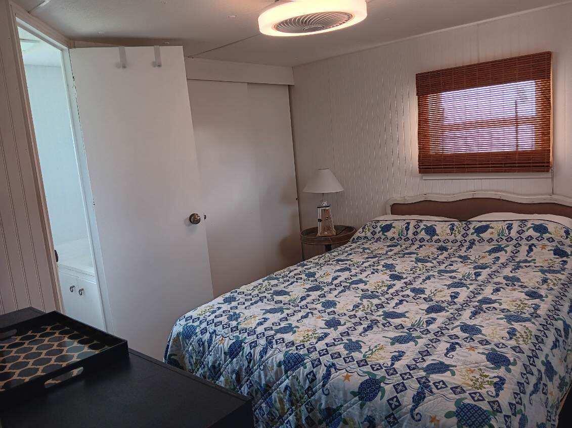 2044 Southeast 34th Lane Okeechobee, FL 34974 - Photo 8 of 11 a bedroom with a bed and a window