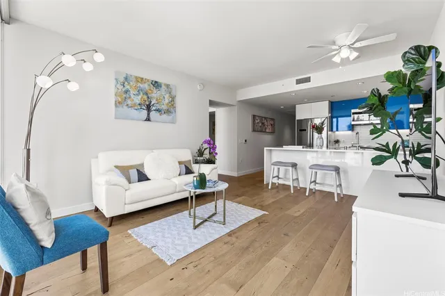 a living room with furniture a rug and a chandelier