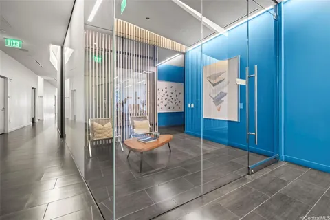 a view of a hallway with entryway door view and wooden floor