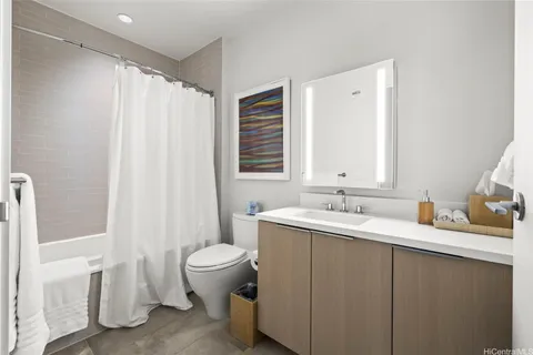a bathroom with a double vanity sink toilet and a mirror