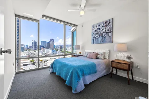 a spacious bedroom with a bed and a large window