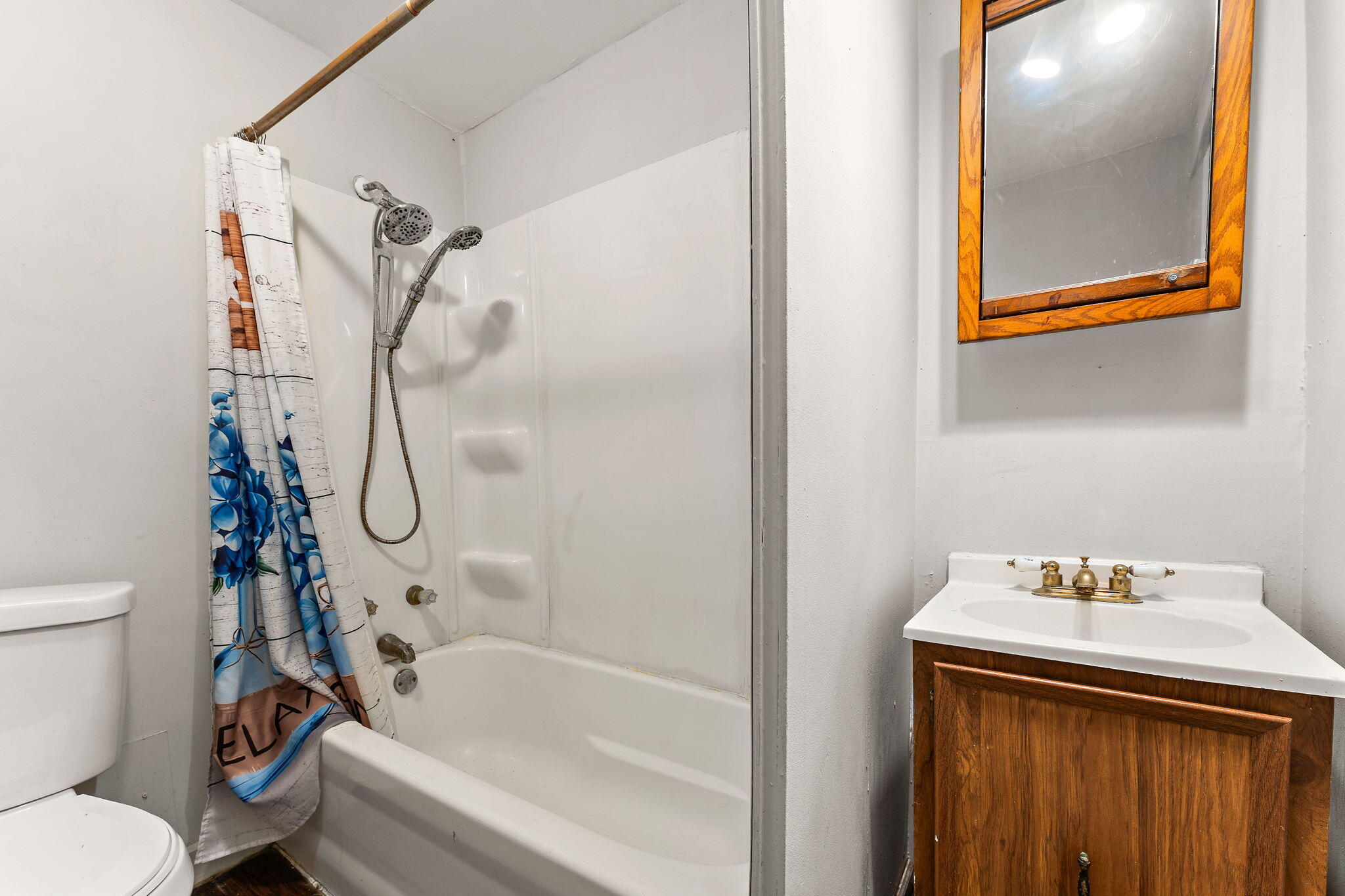 1910 South Calhoun Street Griffith, IN 46319 - Photo 10 of 34 a bathroom with a sink a toilet and shower