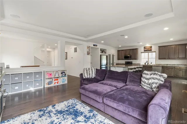 a living room with furniture and a kitchen view