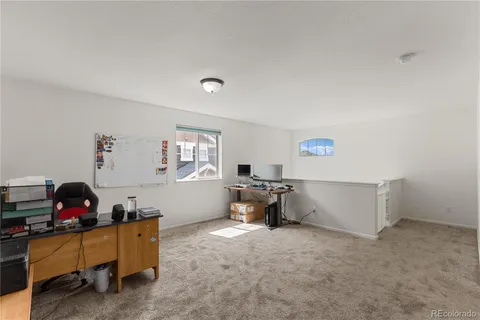 a living room with furniture and a dining table