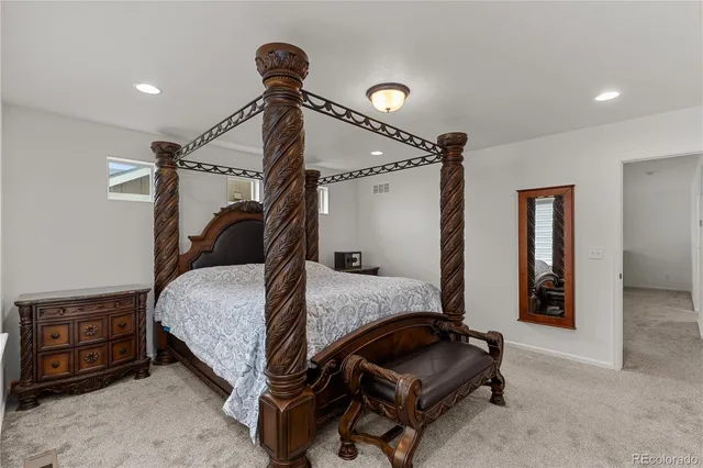 a bedroom with a bed and a mirror