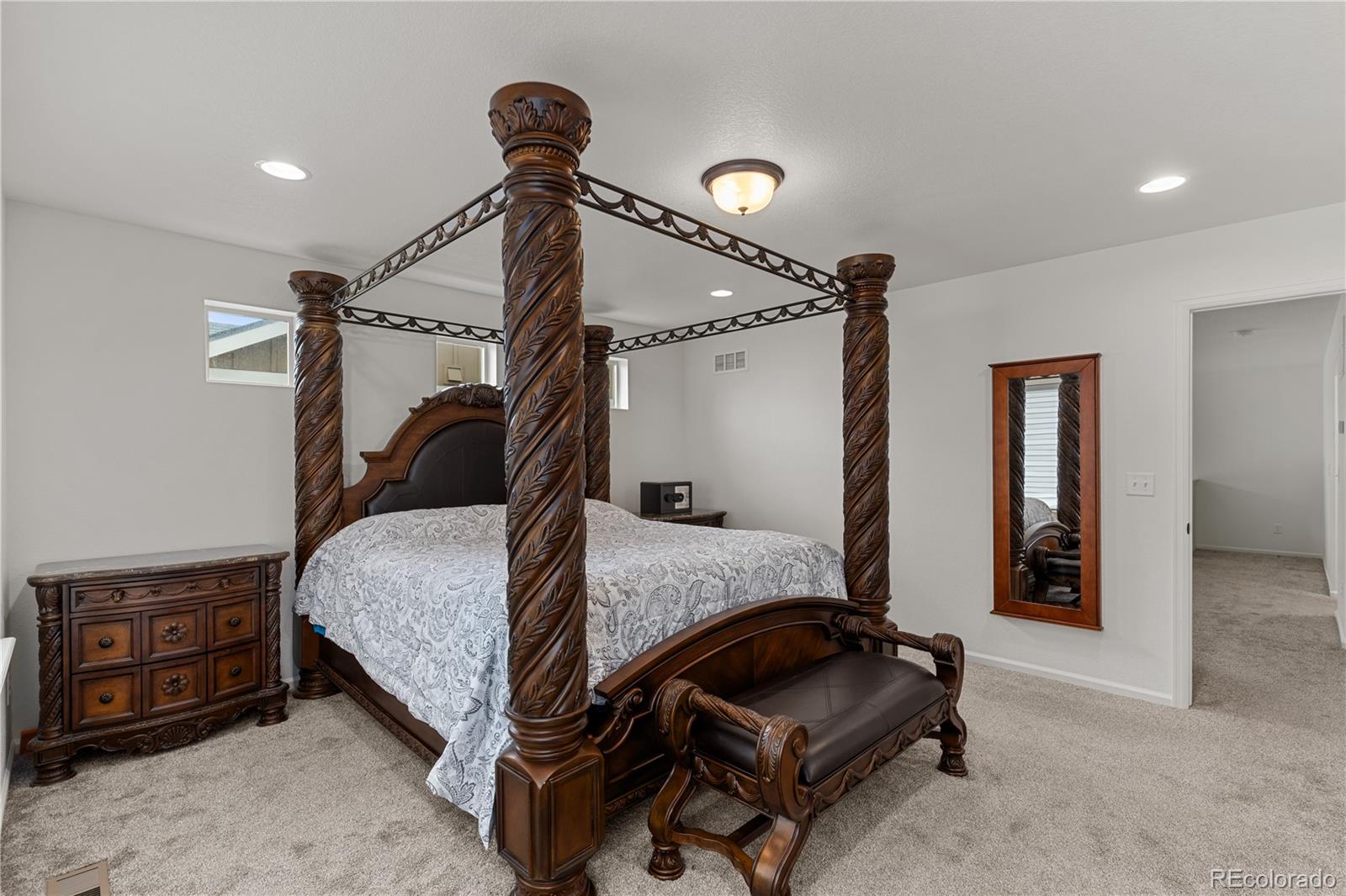 1074 Acadia Circle Erie, CO 80516 - Photo 16 of 50 a bedroom with a bed and a mirror