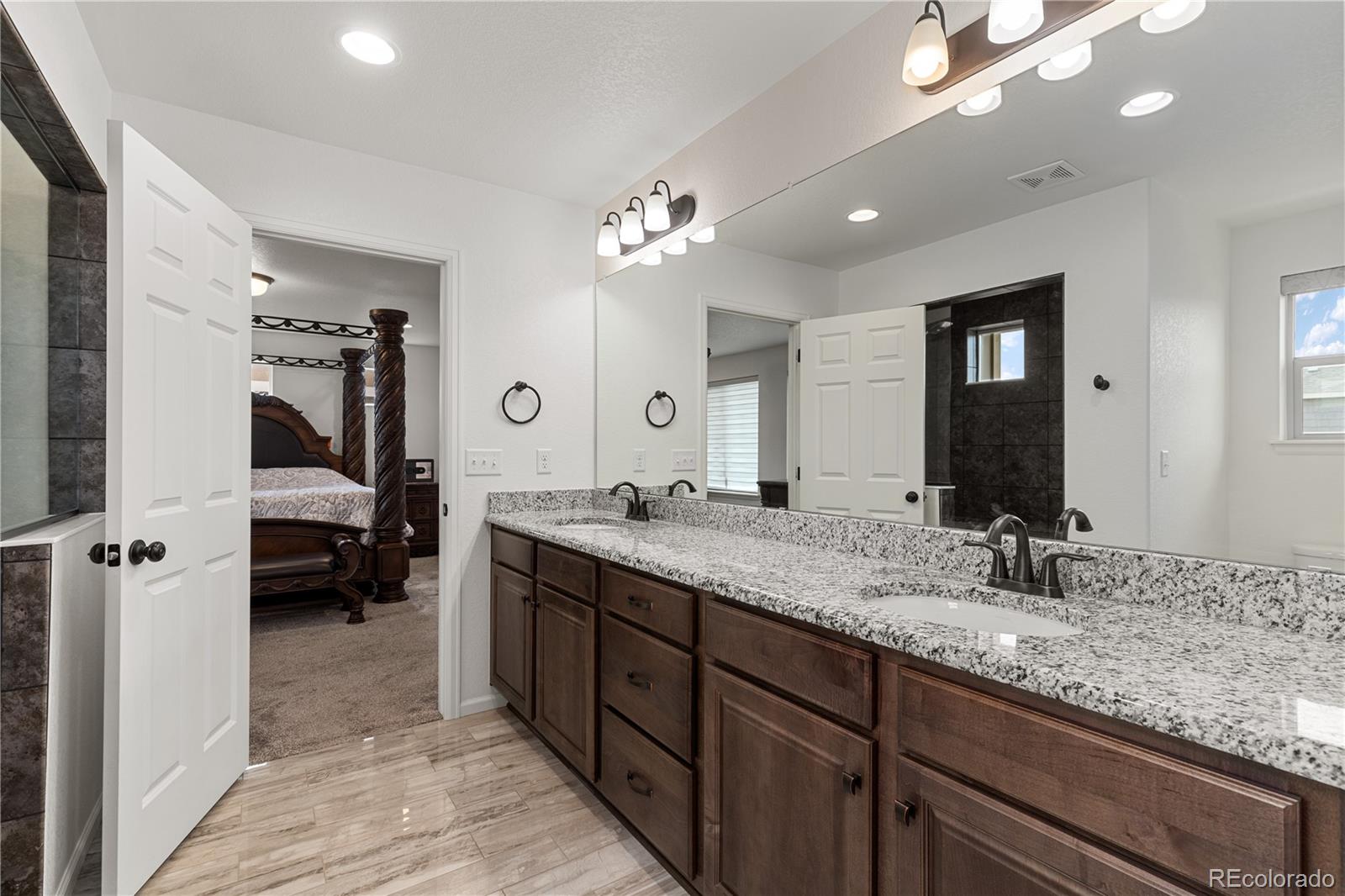 1074 Acadia Circle Erie, CO 80516 - Photo 20 of 50 a bathroom with double vanity and a mirror
