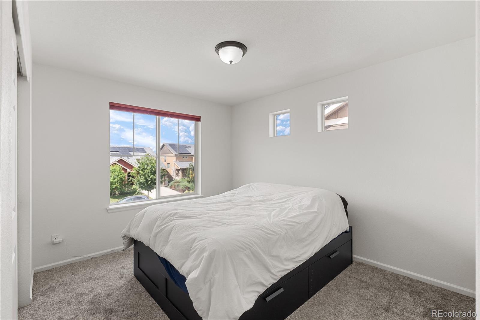 1074 Acadia Circle Erie, CO 80516 - Photo 25 of 50 a bedroom with a bed and a window