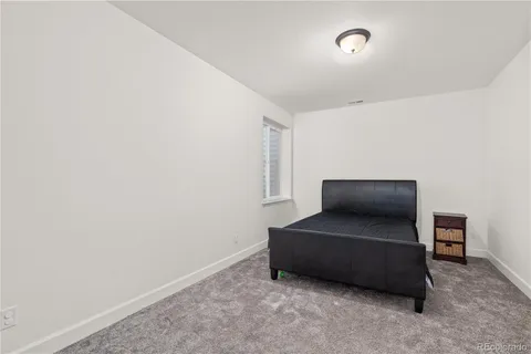 a living room with furniture and a air conditioner vent