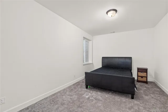 a living room with furniture and a air conditioner vent