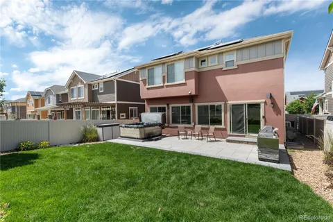 a view of a house with patio and a yard