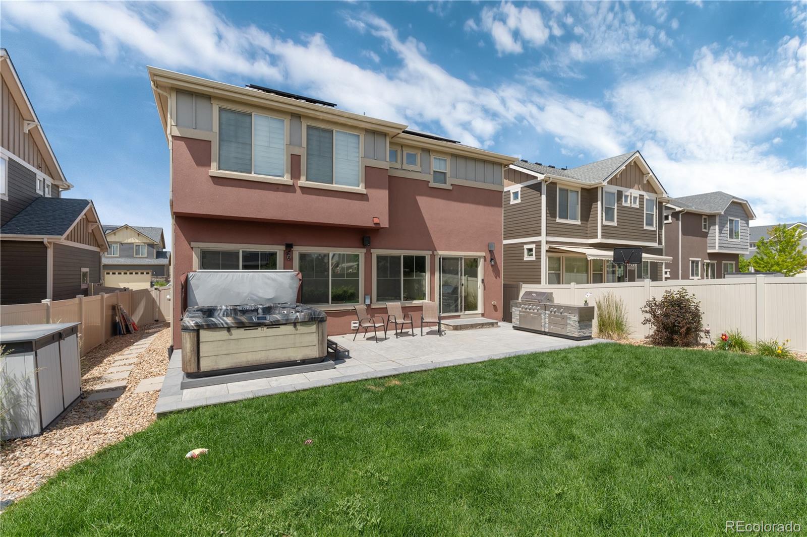 1074 Acadia Circle Erie, CO 80516 - Photo 33 of 50 a view of a house with patio and a yard
